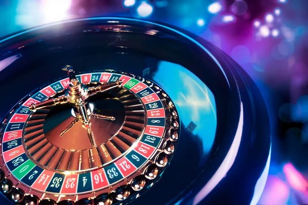 Roulette table setup showing wheel, betting layout, and live dealer